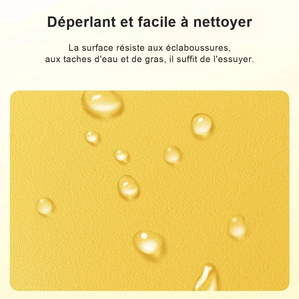 Gros plan sur le revêtement jaune grainé d'une housse d'ordinateur, des gouttes d'eau perlent à la surface.
